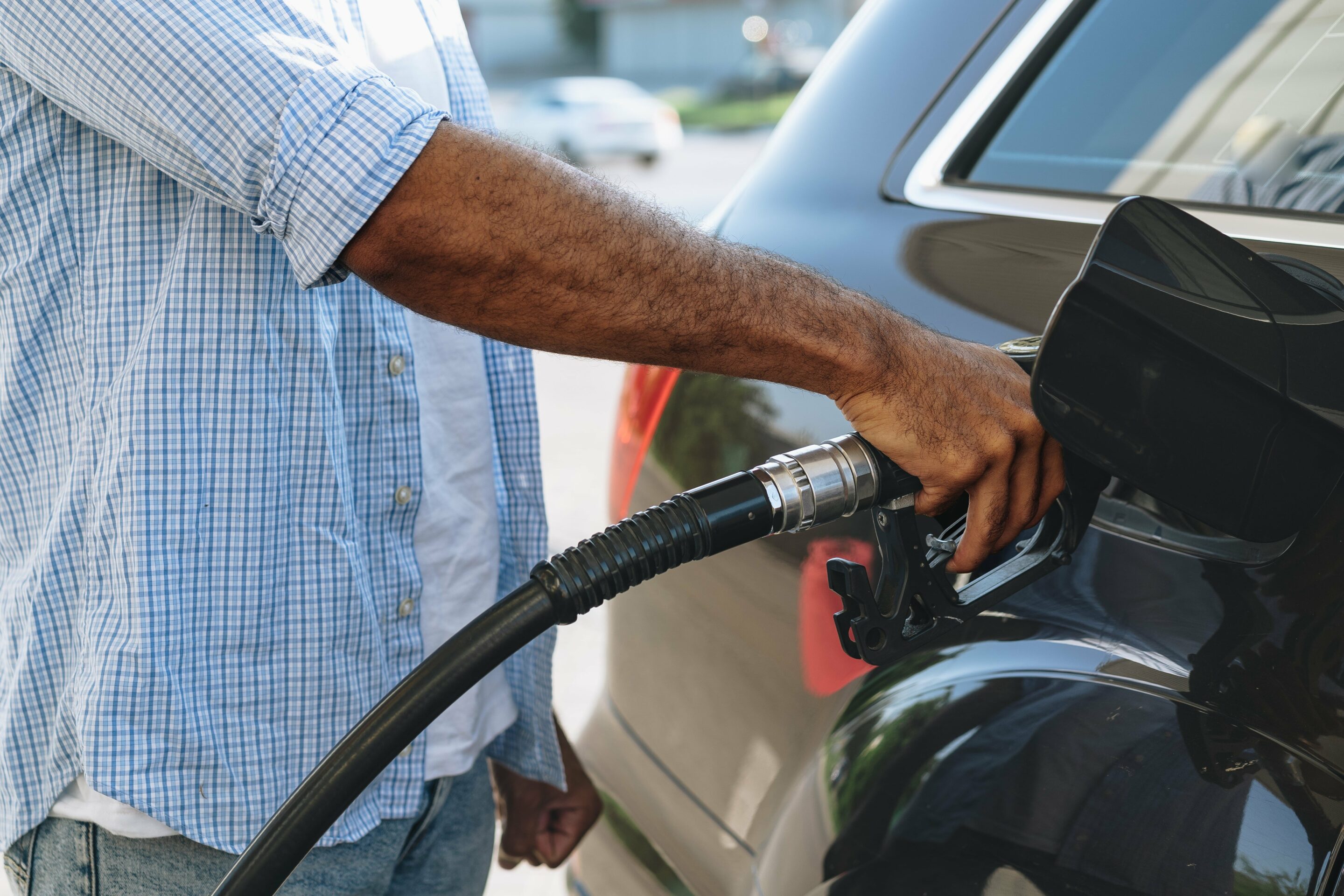 Man Filling Gasoline Fuel Expecting Fuel Tax Credit